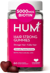 HUM Hair Strong Gummies arranged with vitamins and ingredients icons for hair wellness.