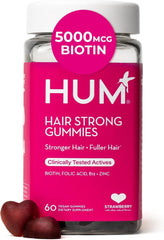 HUM Hair Strong Gummies arranged with vitamins and ingredients icons for hair wellness.