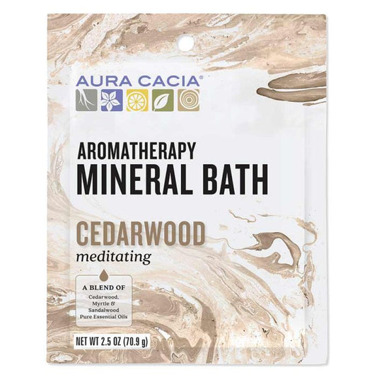 Pouring Aura Cacia Aromatherapy Mineral Bath salts into a warm bath for relaxation