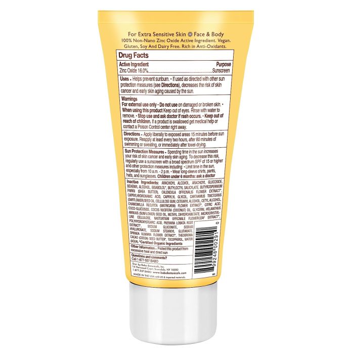 Child’s hand applying Babo Botanicals sheer zinc mineral lotion to face