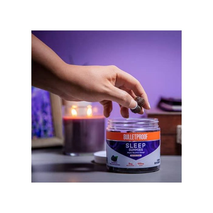 Close‑up of three blackberry-flavored sleep gummies