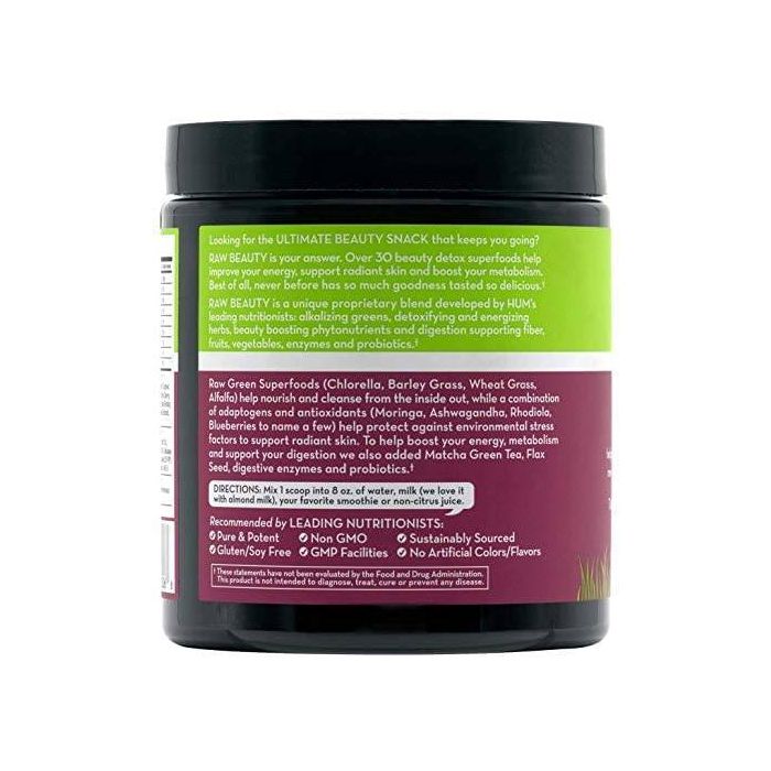 Scoop of HUM Raw Beauty powder being added to a smoothie glass